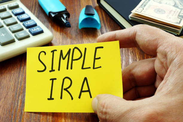 Simple IRA retirement plan in the hands of a man.